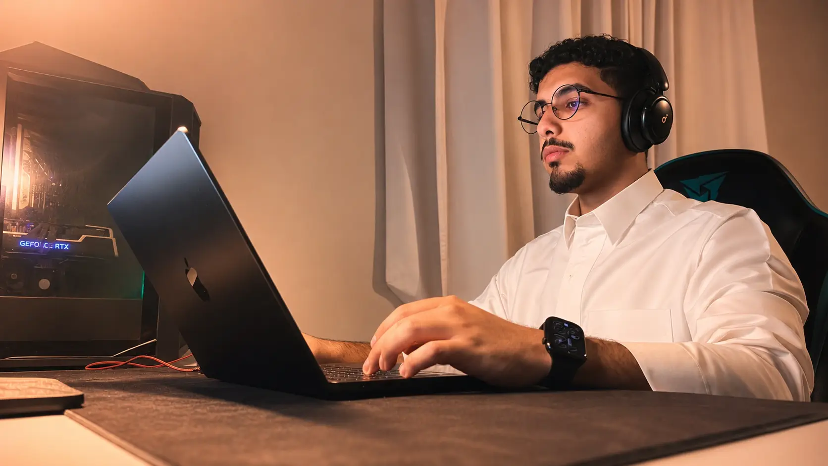 Rayan working at his desk at night, headphones on